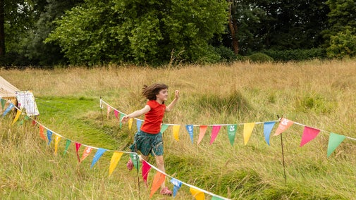 Children running in summer meadow National Trust Summer of play